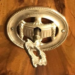 Biedermeier walnut dresser- detail of an escutcheon- styylish
