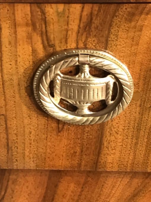 Biedermeier walnut dresser- detail of a brass fitting- styylish