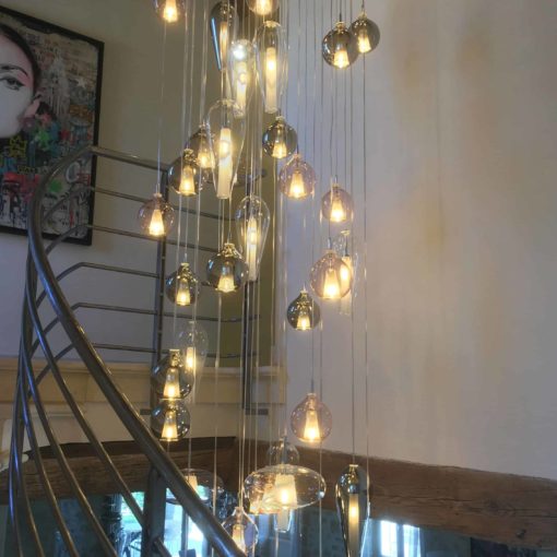 Hand blown glass pendant light-hanging in the staircase- Styylish