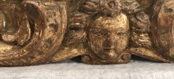 Baroque Gilt wood mirror- detail of the cherub head on the bottom- Styylish