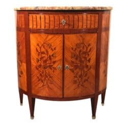 This Napoleon III Demi Lune cabinet is of exquisite quality. The half moon shaped cabinet has two doors and one central drawer. It has a very pretty kingwood veneer with a gorgeous flower marquetry on doors and sides