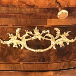 Original 18th century ormolu fittings on a German Baroque chest of drawers, highlighting historic craftsmanship and refined design- Styylish