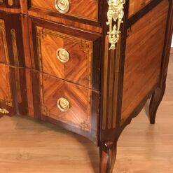 Original gilt-bronze mounts on French Louis XV-Transition chest of drawers, highlighting fine 18th-century craftsmanship- Styylish