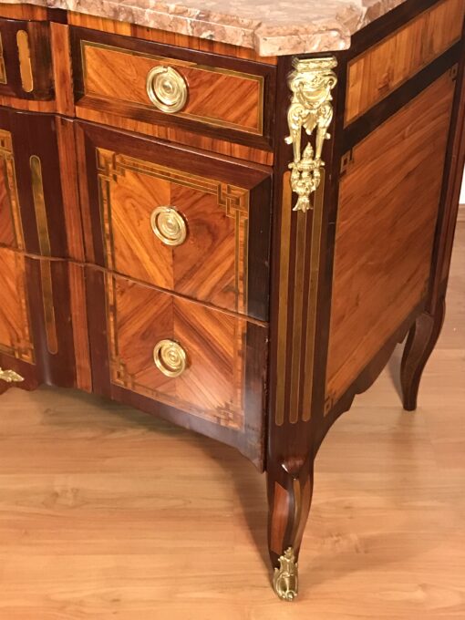 Original gilt-bronze mounts on French Louis XV-Transition chest of drawers, highlighting fine 18th-century craftsmanship- Styylish